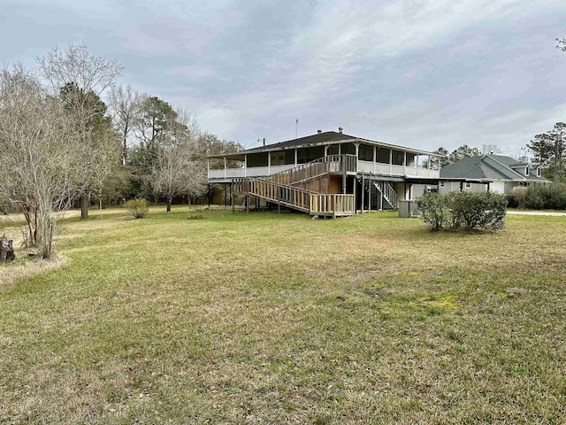 view of yard featuring a wooden deck and stairs