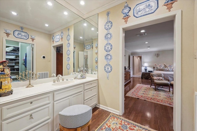 6125 Pinkstaff Ln, Beaumont, TX 77706 - bathroom with ornamental molding, wood finished floors, vanity, and baseboards
