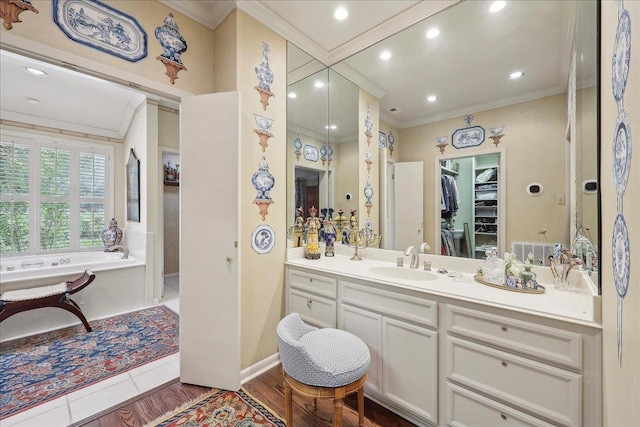 6125 Pinkstaff Ln, Beaumont, TX 77706 - bathroom with ornamental molding, vanity, a bath, a spacious closet, and wood finished floors