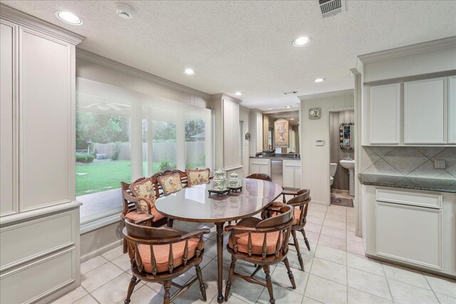 6125 Pinkstaff Ln, Beaumont, TX 77706 - dining space featuring crown molding, light tile patterned flooring, recessed lighting, and a textured ceiling