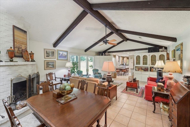 6125 Pinkstaff Ln, Beaumont, TX 77706 - dining room with light tile patterned floors, a ceiling fan, a brick fireplace, and a textured ceiling