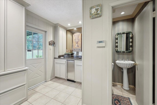 6125 Pinkstaff Ln, Beaumont, TX 77706 - interior space featuring light tile patterned flooring, crown molding, a textured ceiling, and baseboards