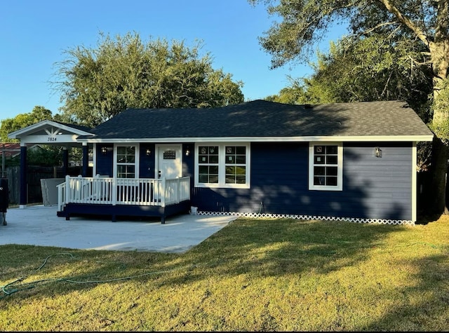 single story home with a front yard, a porch, and a patio