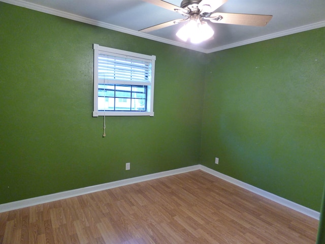 empty room with ceiling fan, wood-type flooring, and ornamental molding