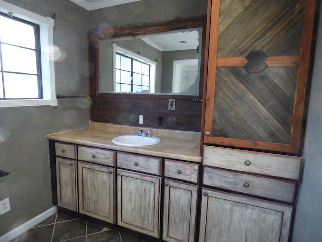 bathroom with crown molding, tile patterned flooring, vanity, and a healthy amount of sunlight