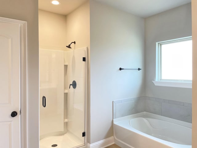 bathroom featuring separate shower and tub