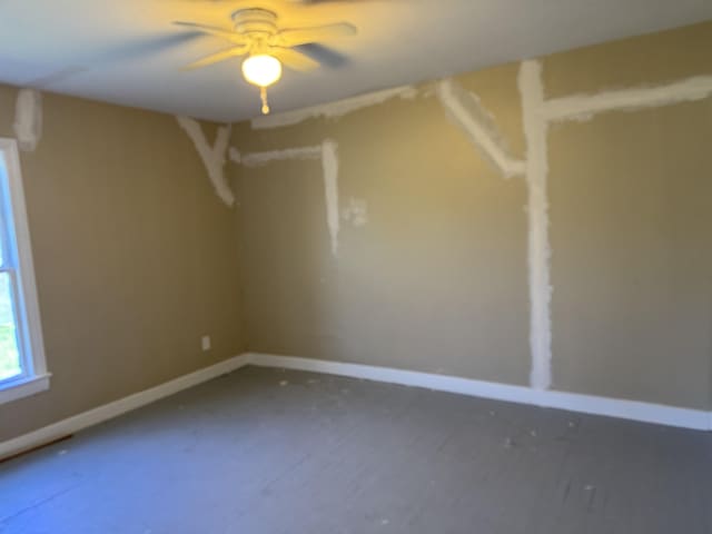 unfurnished room featuring baseboards