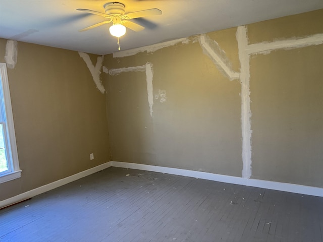 spare room featuring ceiling fan, baseboards, and hardwood / wood-style floors