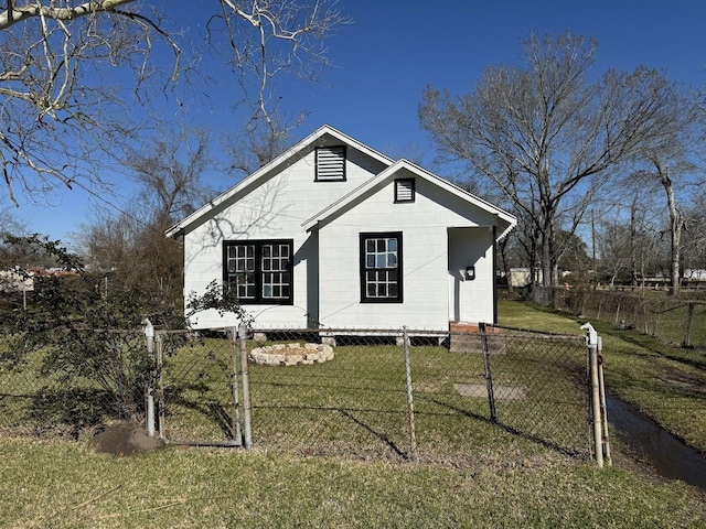 bungalow-style house featuring a front lawn and a fenced front yard