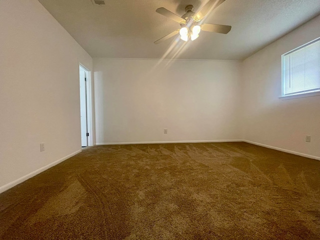 empty room with ceiling fan and carpet floors