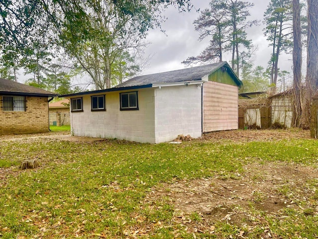 view of outbuilding featuring a lawn