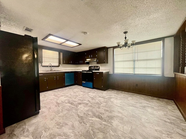 kitchen featuring dishwasher, stainless steel electric stove, black fridge, sink, and a textured ceiling