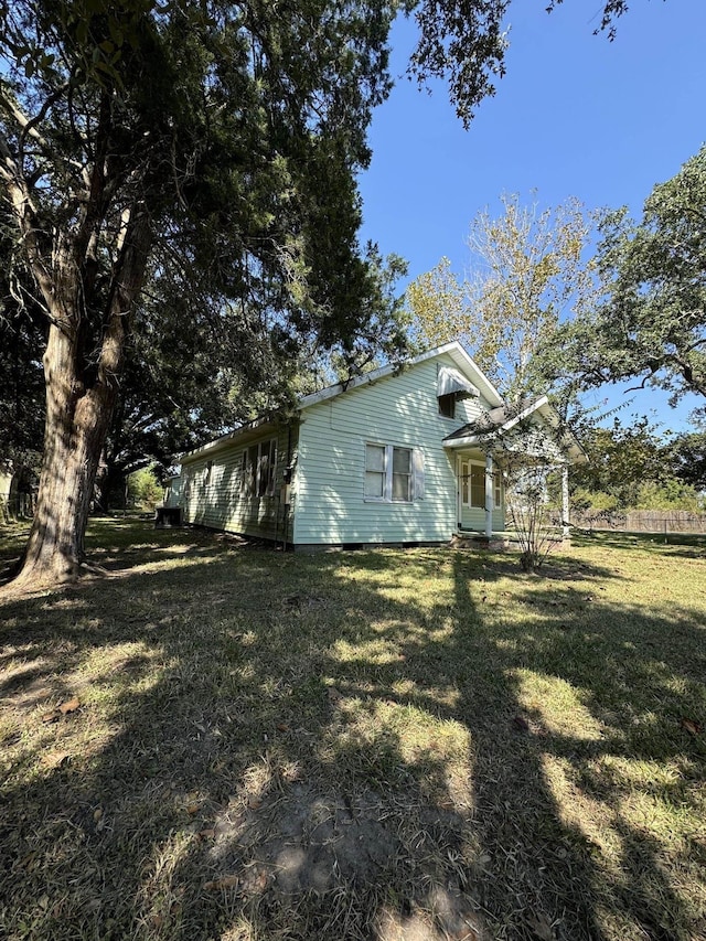 view of side of home with a lawn