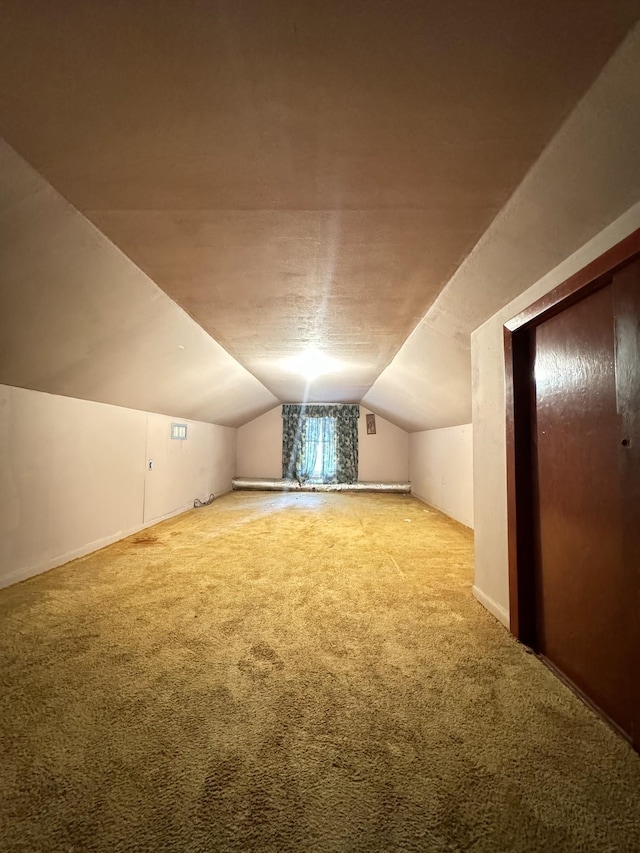 bonus room with carpet and lofted ceiling