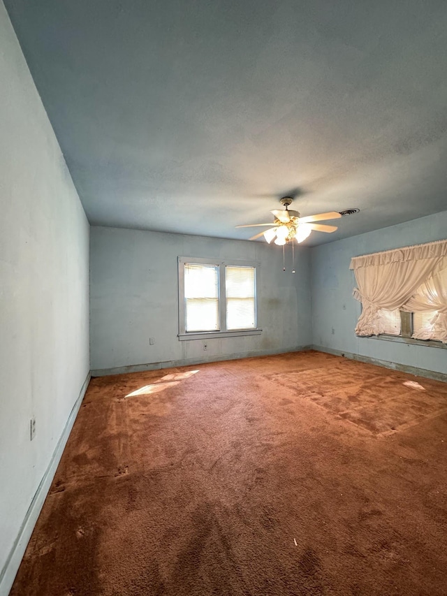 carpeted empty room featuring ceiling fan