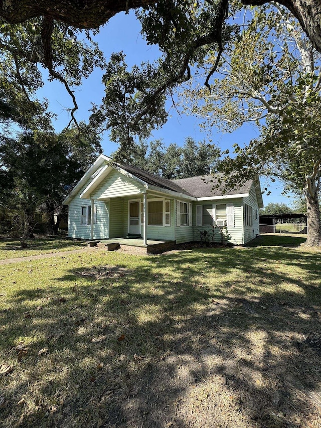 view of front of house featuring a front yard and covered porch