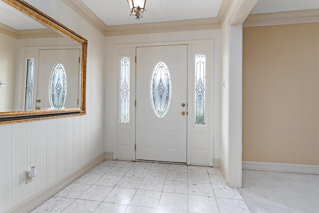 foyer entrance featuring crown molding and baseboards