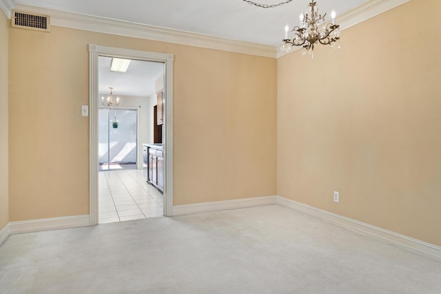 spare room featuring crown molding, a notable chandelier, light carpet, and visible vents