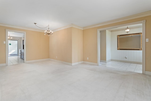 empty room with baseboards, ornamental molding, carpet flooring, and a chandelier