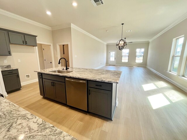 kitchen featuring visible vents, an island with sink, ornamental molding, a sink, and dishwasher