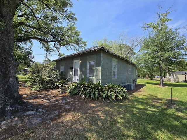 1022 Wilson St, Port Neches, TX 77651 - view of home's exterior with central AC unit and a lawn