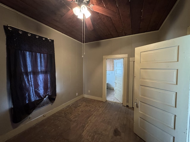 empty room featuring hardwood / wood-style floors, crown molding, ceiling fan, and wooden ceiling