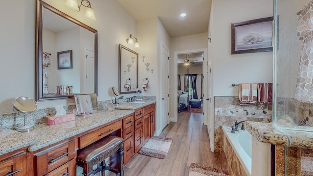 15360 Hercules Dr, Beaumont, TX 77713 - ensuite bathroom with vanity, a bath, wood finished floors, and a ceiling fan