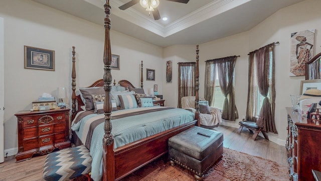 15360 Hercules Dr, Beaumont, TX 77713 - bedroom with ornamental molding, wood finished floors, a tray ceiling, ceiling fan, and recessed lighting