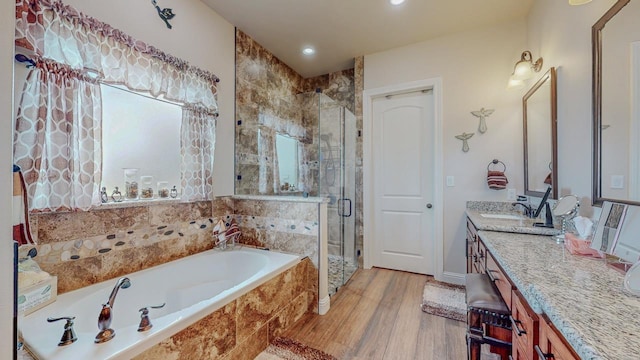 15360 Hercules Dr, Beaumont, TX 77713 - bathroom with vanity, a shower stall, a garden tub, wood finished floors, and recessed lighting