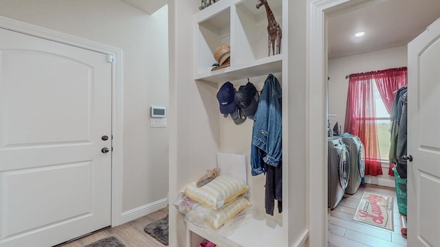 15360 Hercules Dr, Beaumont, TX 77713 - mudroom with washing machine and clothes dryer and light wood-type flooring