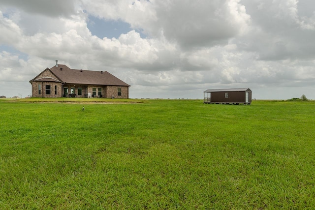 15360 Hercules Dr, Beaumont, TX 77713 - view of green lawn featuring a storage unit