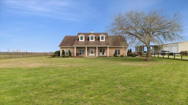 cape cod house with a front yard