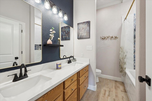 full bathroom with shower / tub combo with curtain, vanity, wood-type flooring, and toilet