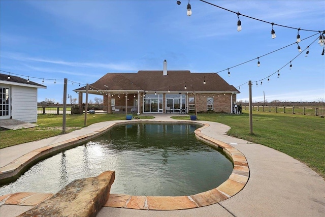 view of swimming pool featuring a patio area and a lawn