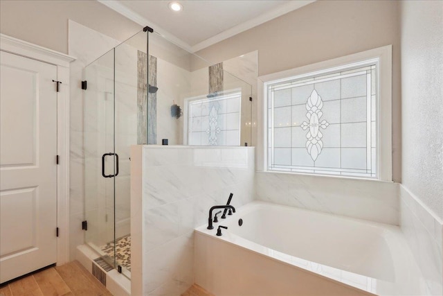 bathroom featuring independent shower and bath, ornamental molding, and wood-type flooring