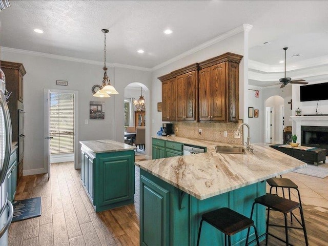 kitchen with crown molding, sink, a center island, and dark hardwood / wood-style floors