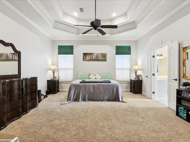 bedroom with ceiling fan, a raised ceiling, light carpet, and multiple windows