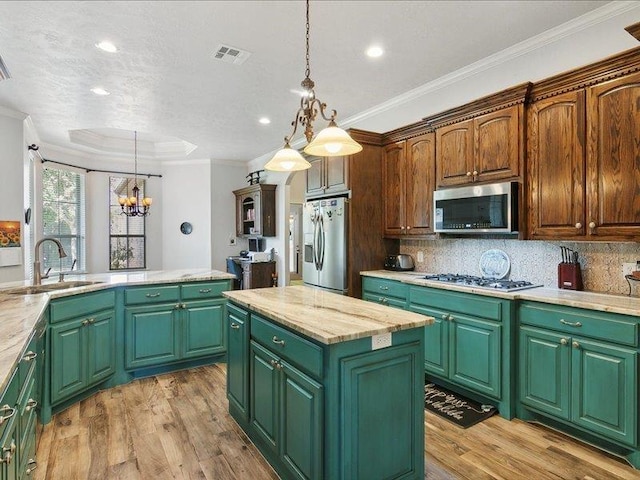 kitchen with green cabinets, a center island, and stainless steel appliances