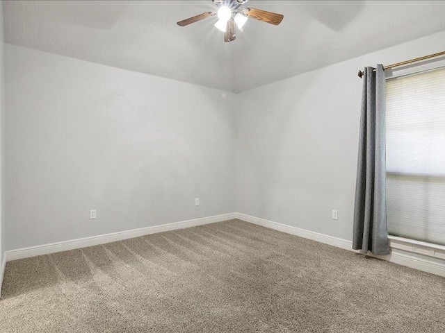 carpeted empty room featuring ceiling fan