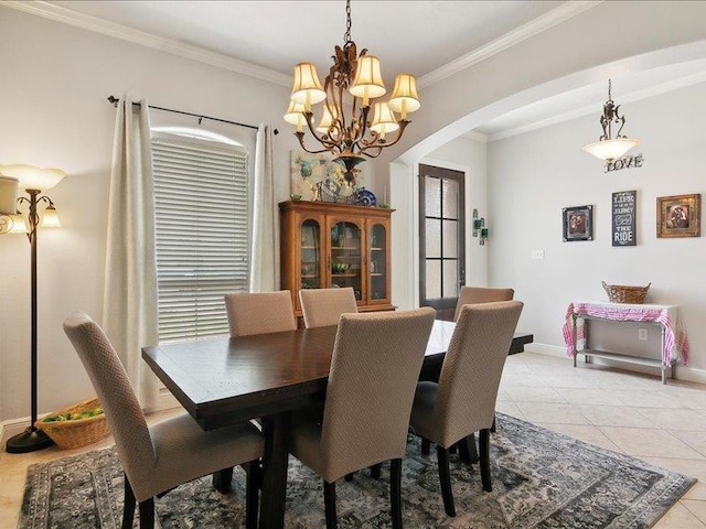 dining area with light tile patterned floors, ornamental molding, and an inviting chandelier