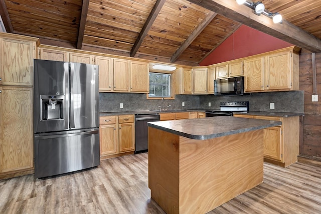 kitchen featuring vaulted ceiling with beams, a center island, stainless steel appliances, and light hardwood / wood-style floors