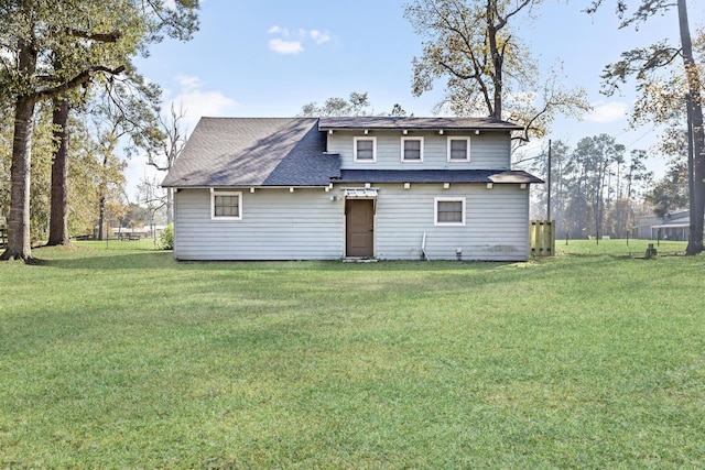 back of property with a yard