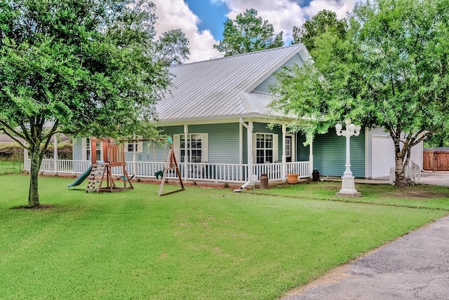 country-style home featuring a garage, a playground, and a front lawn