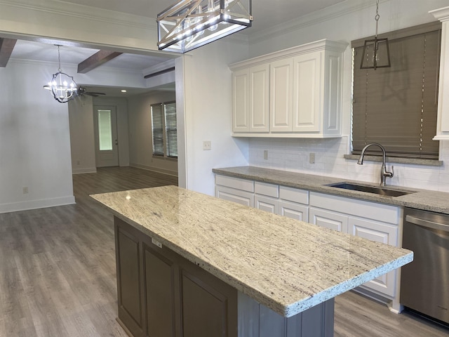 kitchen featuring sink, beam ceiling, dishwasher, white cabinetry, and hanging light fixtures