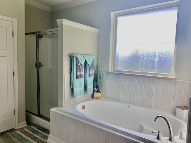 bathroom with wood-type flooring, ornamental molding, and shower with separate bathtub