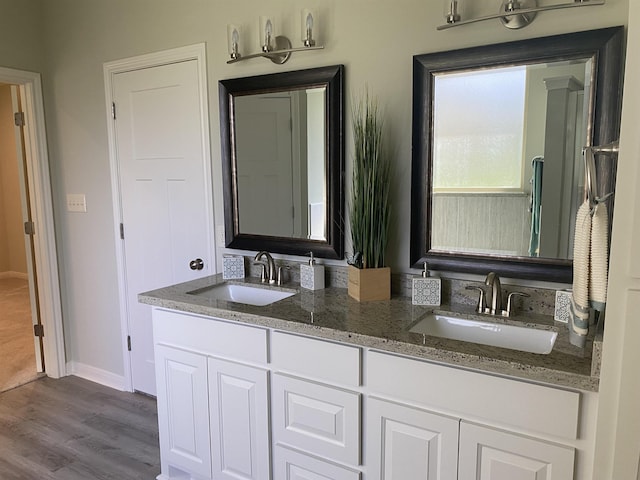 bathroom with hardwood / wood-style floors and vanity