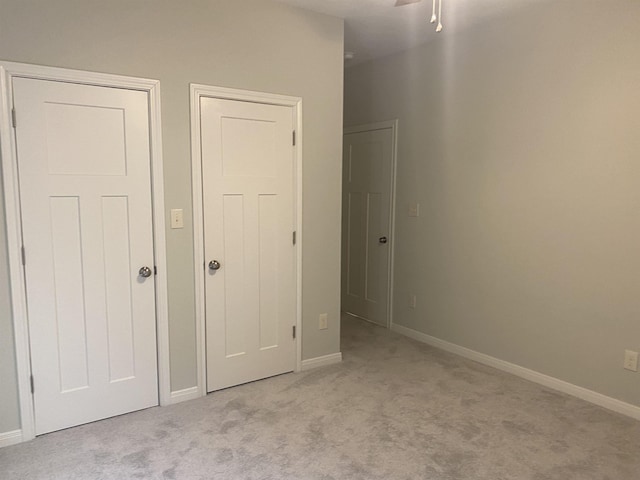 unfurnished bedroom with light colored carpet