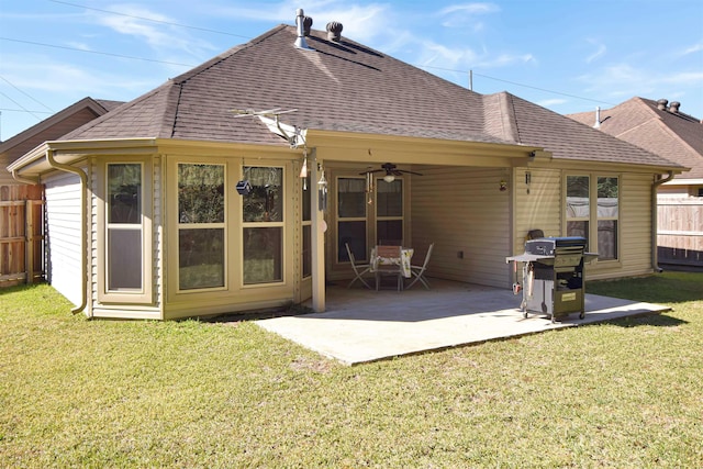 back of property with ceiling fan, a patio area, and a yard