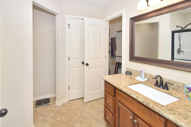 bathroom with tile patterned flooring and vanity