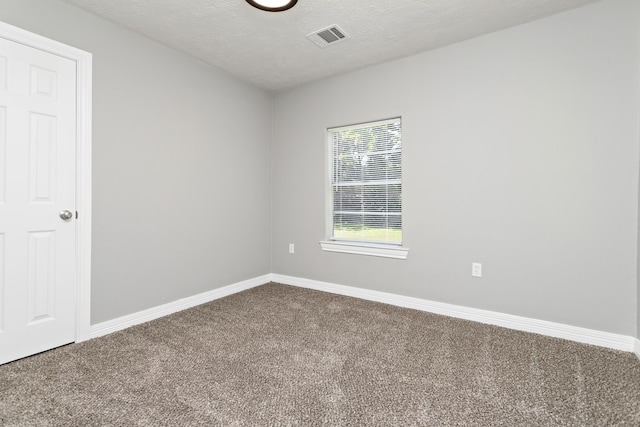 590 Parks St, Silsbee, TX 77656 - empty room featuring baseboards, carpet flooring, visible vents, and a textured ceiling